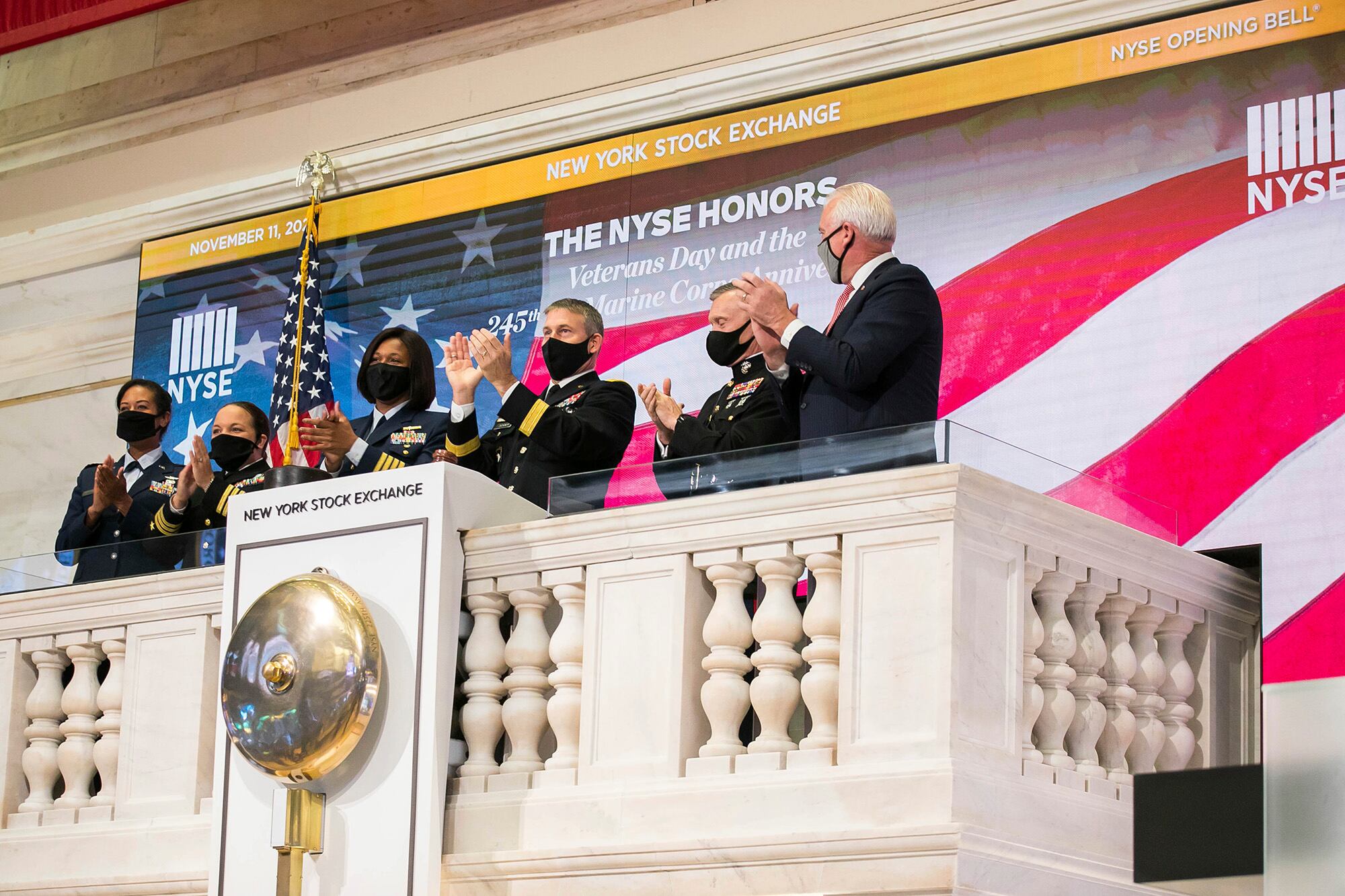 Members of the U.S. Coast Guard, Air Force, Navy and Army ring the opening bell at the New York Stock Exchange on Veterans Day, Wednesday, Nov. 11, 2020, in New York.