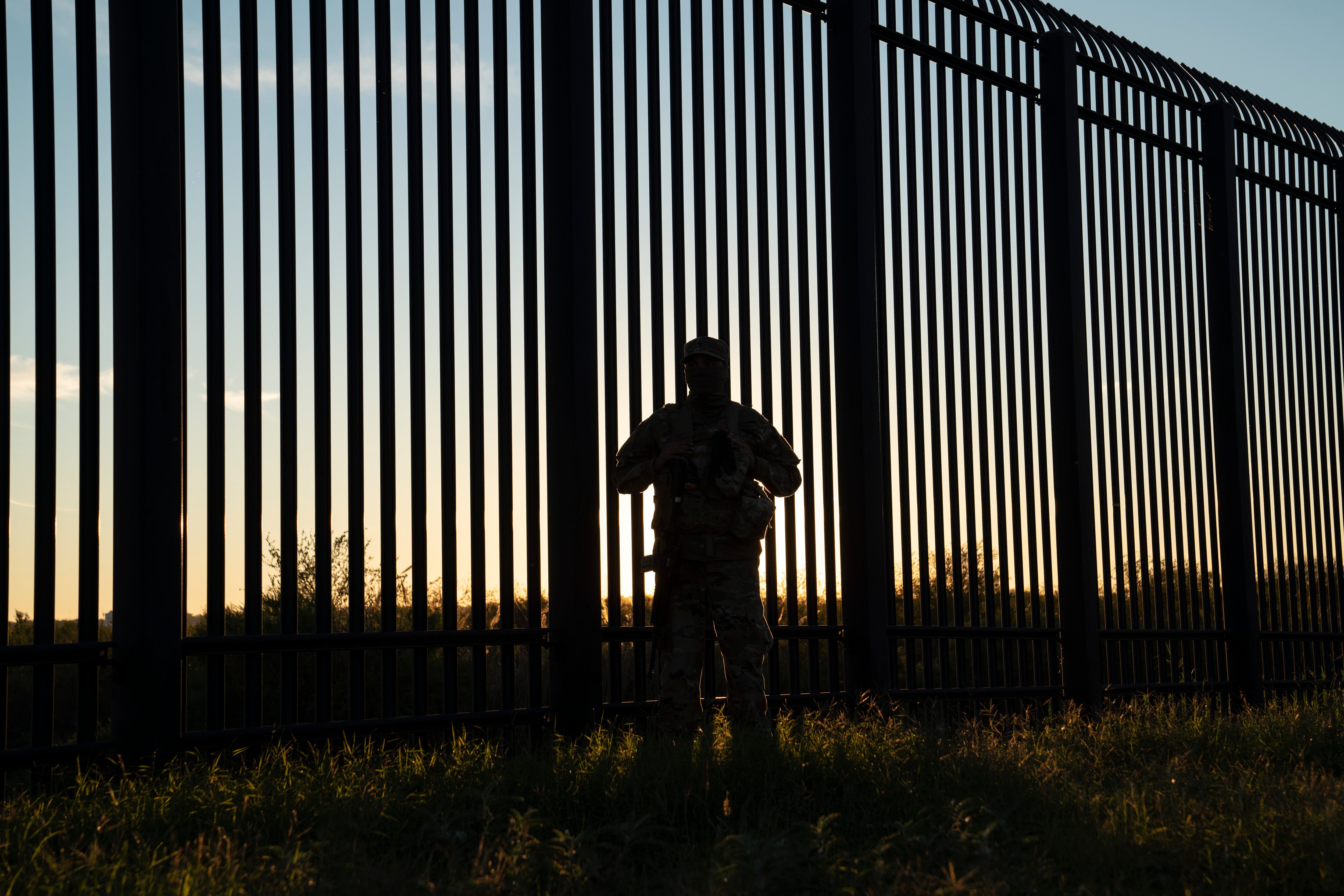 A National Guard soldier oversees an area where the border wall ends in Del Rio, on Nov. 7, 2021.