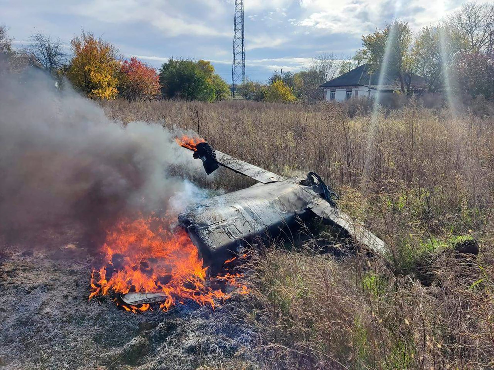 In this photo provided by the Ukrainian Defense Ministry Press Service, fragments of a Russian rocket that was shot down by the Ukrainian air defense system burn down in the village of Kipti, Chernihiv region, Ukraine, Wednesday, Oct. 19, 2022.