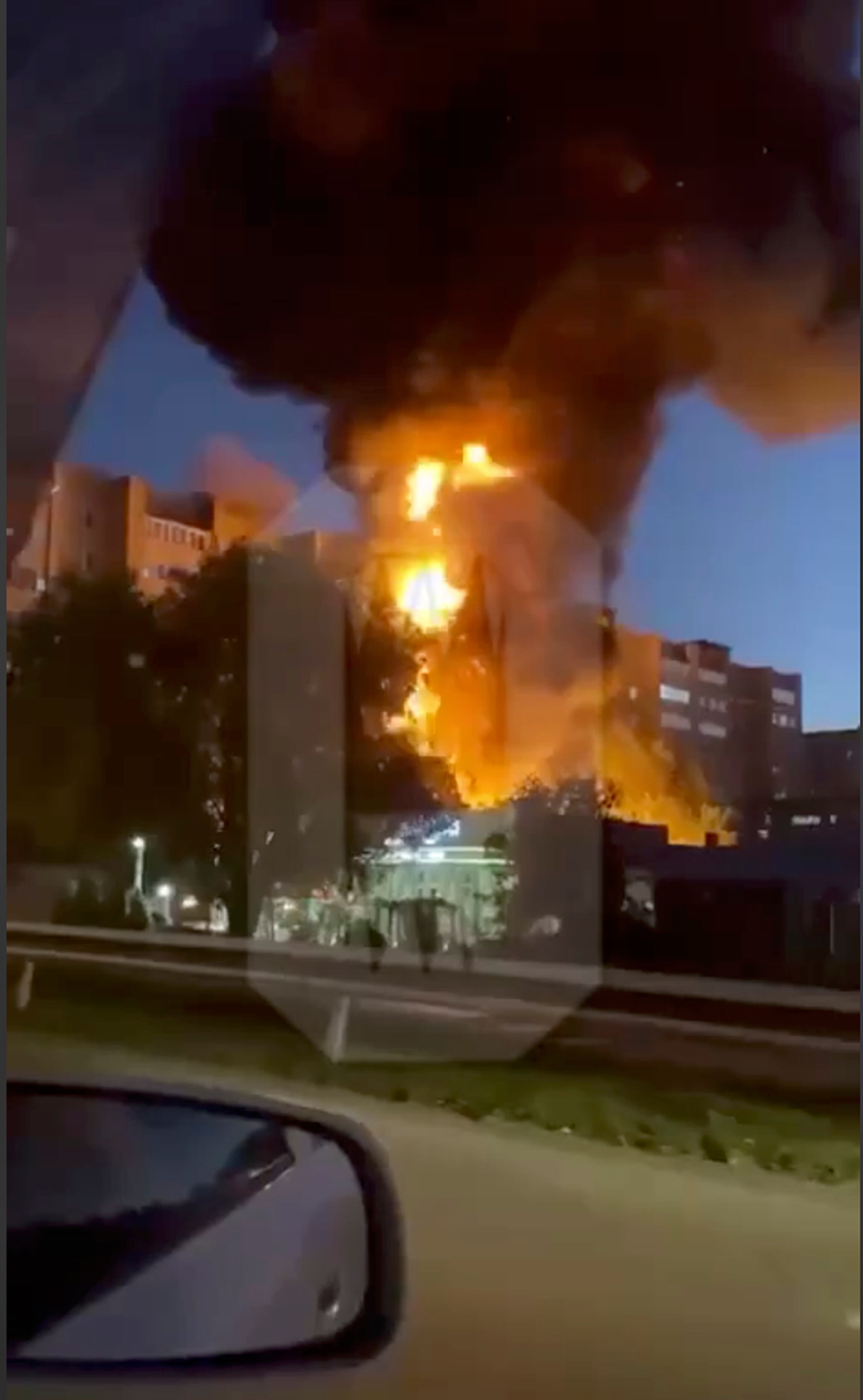 In this handout photo taken from video released by Ostorozhno Novosty, flames and smoke rise from the scene where a warplane crashed into a residential area in Yeysk, Russia, Monday, Oct. 17, 2022.