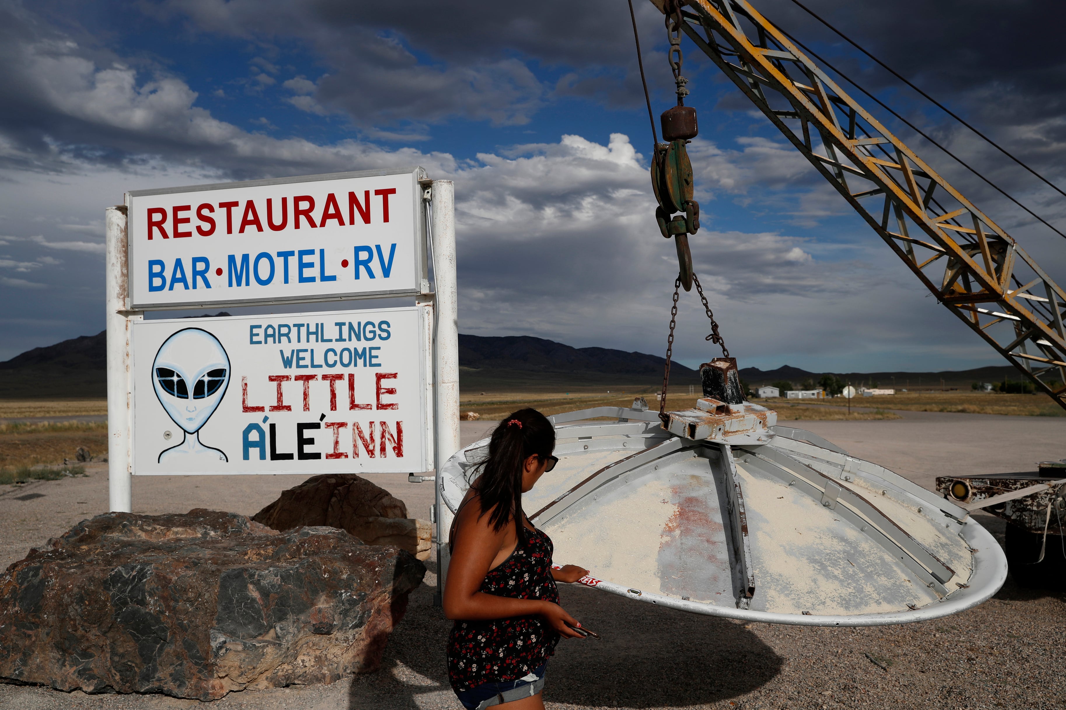 A woman looks at a UFO display outside of the Little A'Le'Inn, in Rachel, Nev., the closest town to Area 51, July 22, 2019.